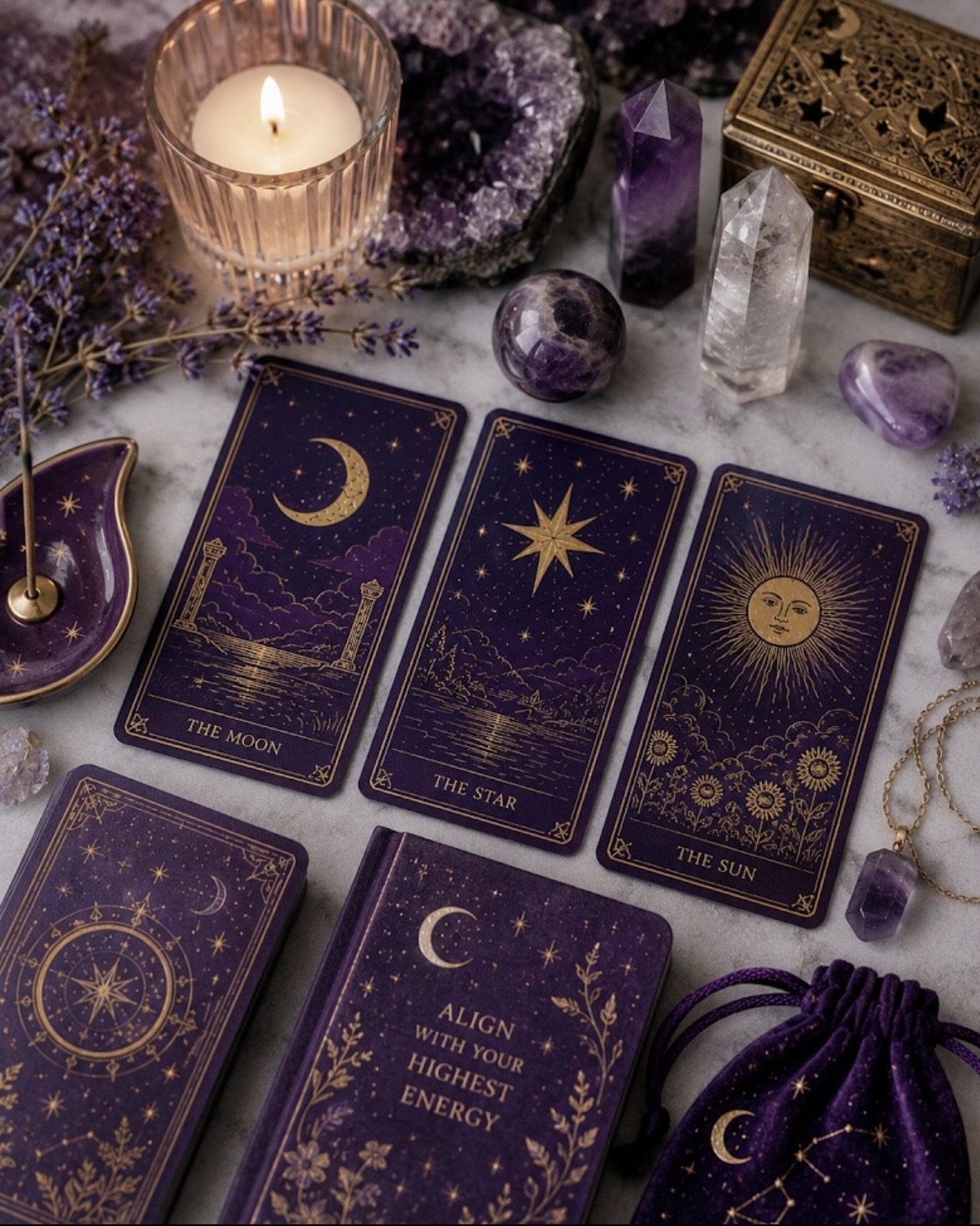 Purple and gold tarot cards showing The Moon, The Star, and The Sun laid on marble with amethyst, quartz, and lavender — the Rider-Waite majors most clients ask about.